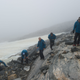 Glacial archaeologists performing fieldwork at Lendbreen, Norway.